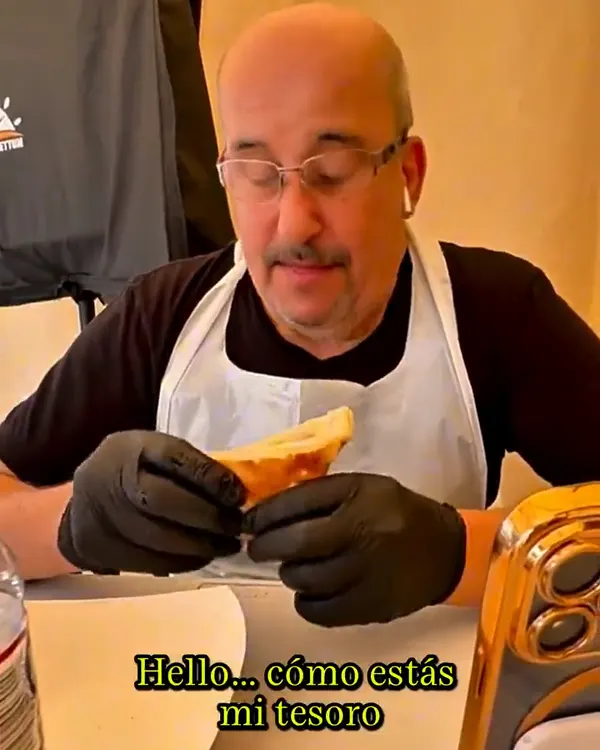 Raed's father tasting a dish at Ta-Umm