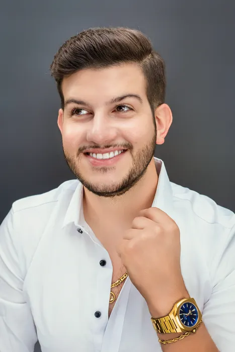 Raed smiling in a white shirt